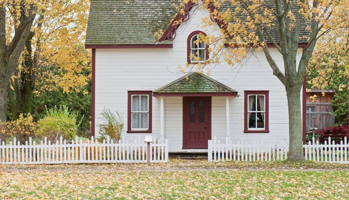 Single family home with a picket white fence.