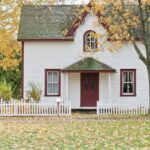 Single family home with a picket white fence.