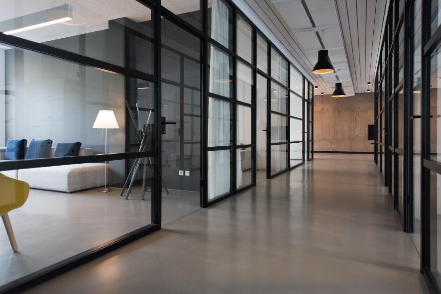 A photo of an office hallway between glass doors used to illustrate the importance of crisis-proofing commercial real estate.