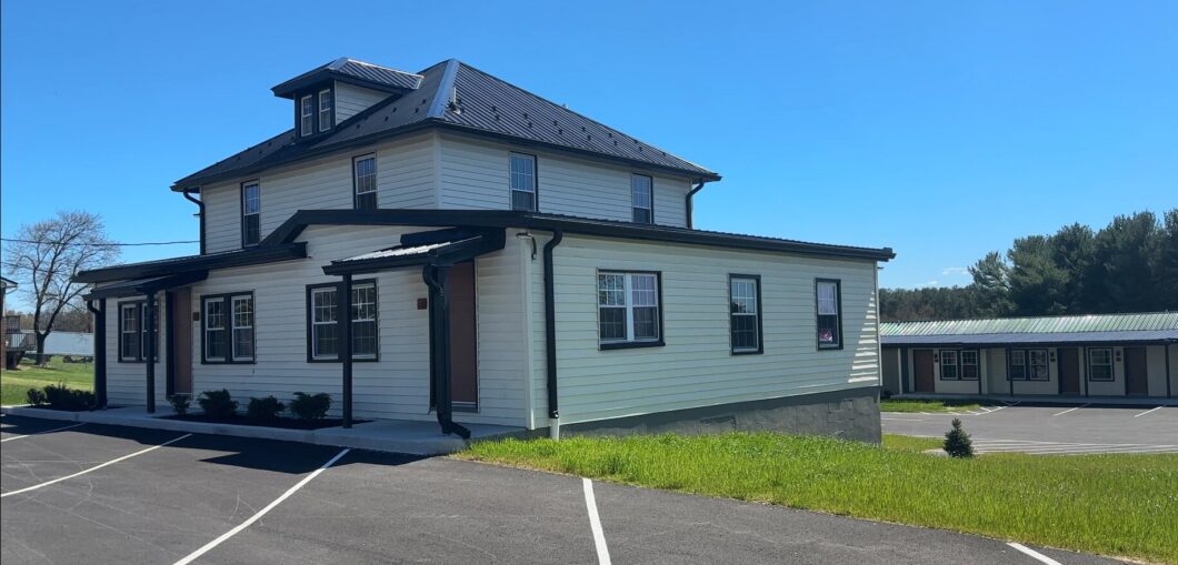 15149 Bloyers Ave exterior with metal roof, lawn, and paved parking