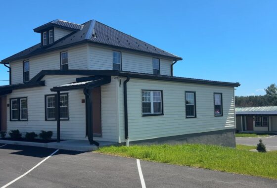 15149 Bloyers Ave exterior with metal roof, lawn, and paved parking
