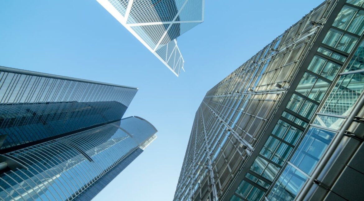 Three commercial buildings under the blue sky.