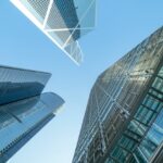 Three commercial buildings under the blue sky.